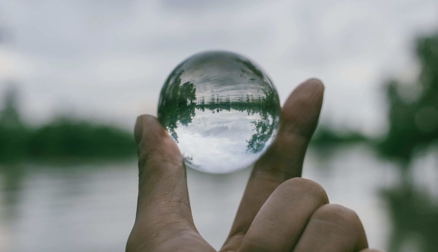 Hand holding a transparent sphere
